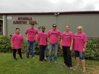 Picture of 6 adult volunteers standing in front of our elementary school dressed in pink t-shirts from the City of Santa Rosa. 